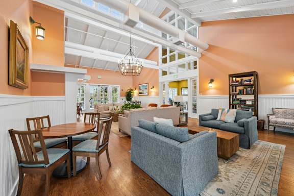 A living room with a grey couch and a wooden table.