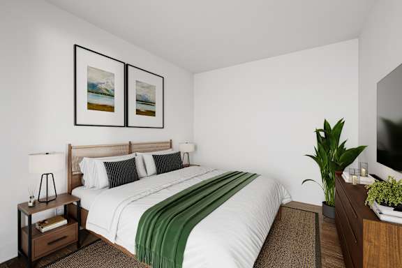 A bedroom with a large bed and two pictures on the wall.