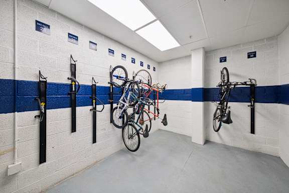 A bike parking area with bikes hanging on hooks.