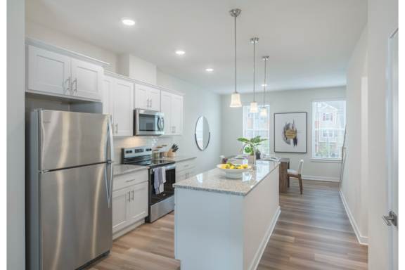 A modern kitchen with stainless steel appliances and a center island.