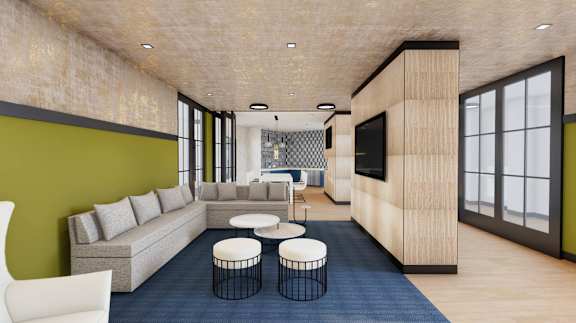 A modern living room with a grey sofa and a white chair.