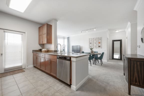 a kitchen with an island and a living room with a dining room