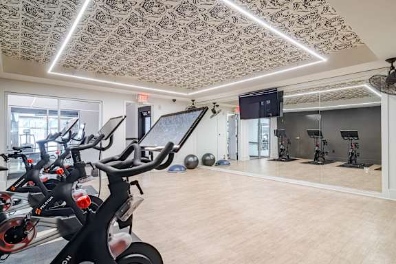 A room with exercise equipment and a patterned ceiling.