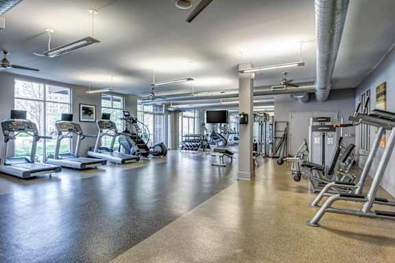 A spacious gym with treadmills, elliptical machines, and other exercise equipment.