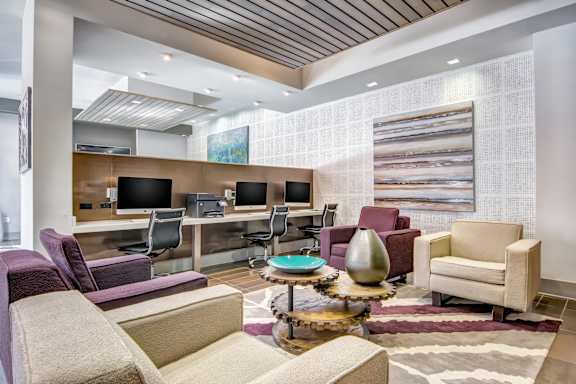 A modern living room with a purple chair and a coffee table.