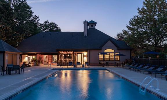 a house with a swimming pool at dusk