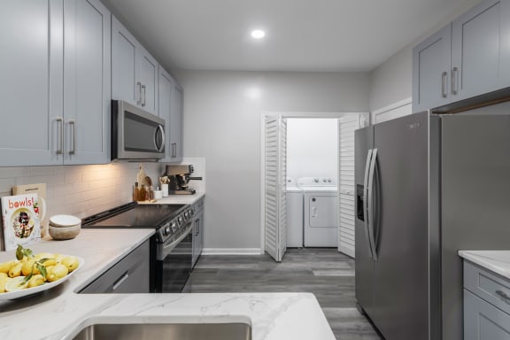 a kitchen with stainless steel appliances and white cabinets