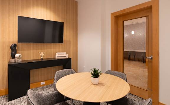 A modern room with a wooden table and chairs.