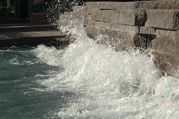 Water splashing against a stone wall.