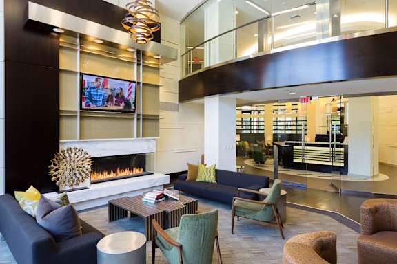 A modern living room with a fireplace and a television.