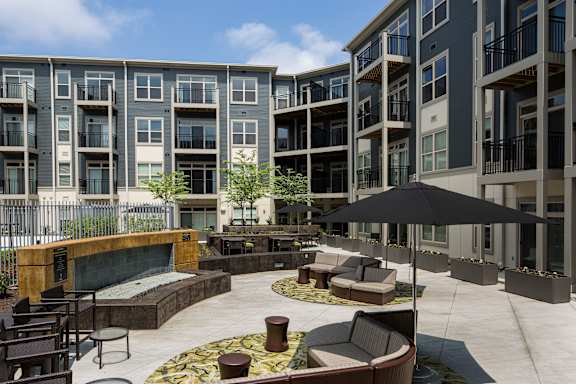 A large outdoor patio area with a fireplace and seating area.