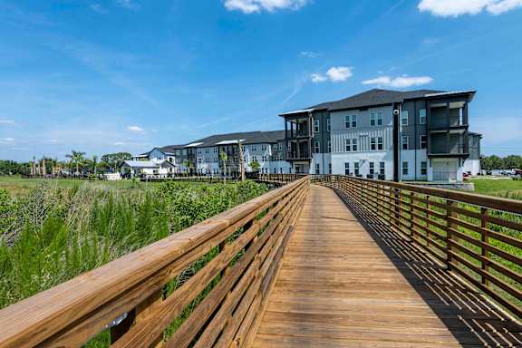 Walking trail connecting buildings at The Crossing at Palm Aire