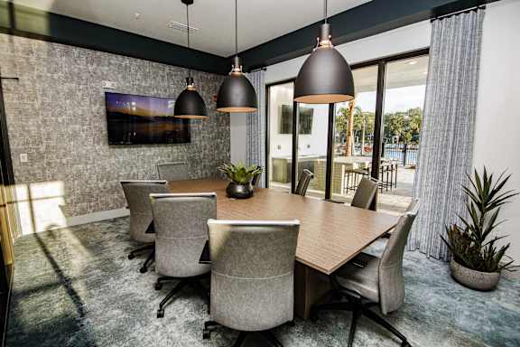A conference room with a long table and chairs.
