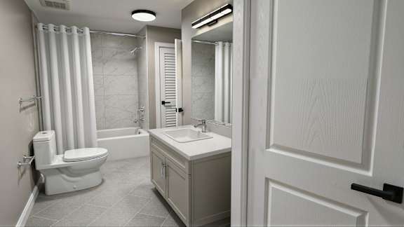 A white bathroom with a toilet, sink, and shower.