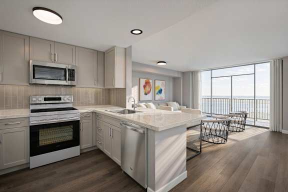 A modern kitchen with a large island and stainless steel appliances.