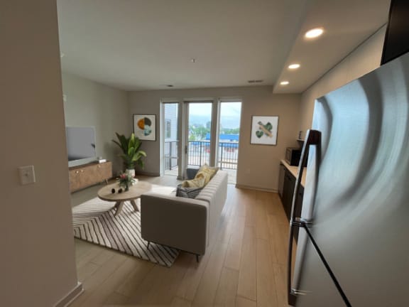 a living room with a couch and a refrigerator