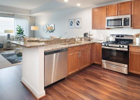 A kitchen with wooden cabinets and a granite countertop.