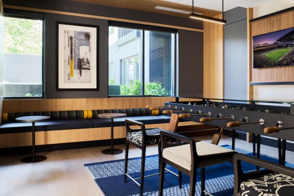 a room filled with tables and chairs and a large window