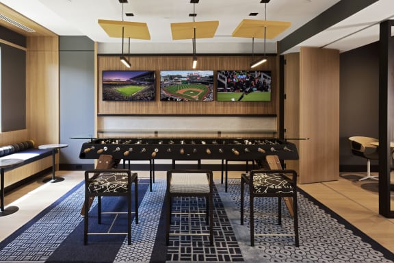 a large conference room with a long table and chairs and a television on the wall