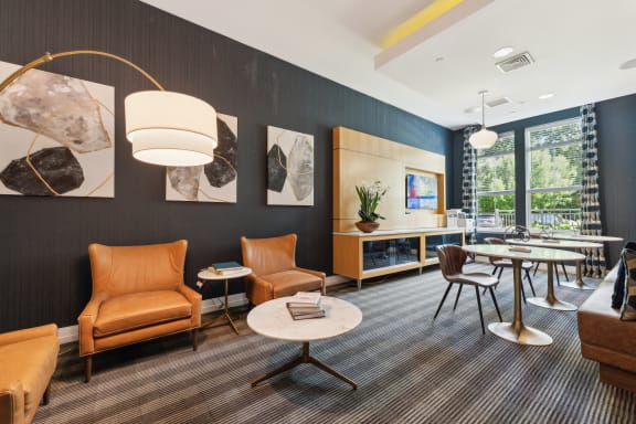a lounge area with chairs and tables and a fireplace