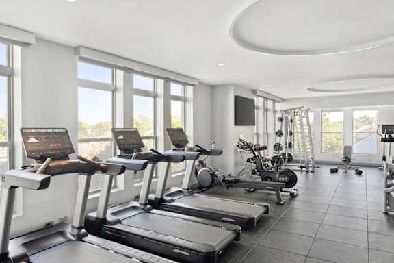 A gym with treadmills and exercise equipment.
