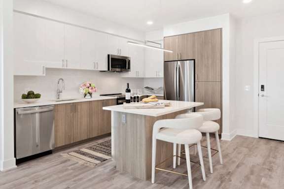A kitchen with a white counter and a refrigerator.