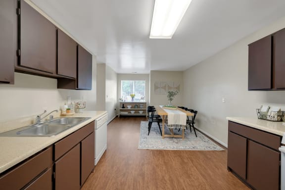 a kitchen and dining room with a table and chairs