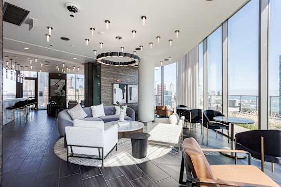 A modern living room with a large window overlooking the city.