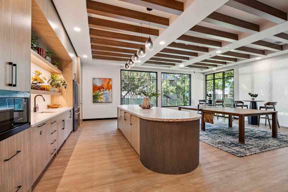 A modern kitchen with wooden cabinets and a large island.
