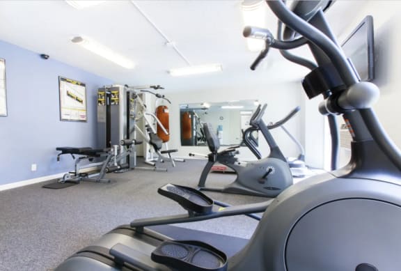 Fitness Center with various machines and weights  at Castlewood Apartments in Walnut Creek, CA