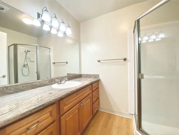 Spacious Bathroom with glass encased shower at Castlewood Apartments in California 94596
