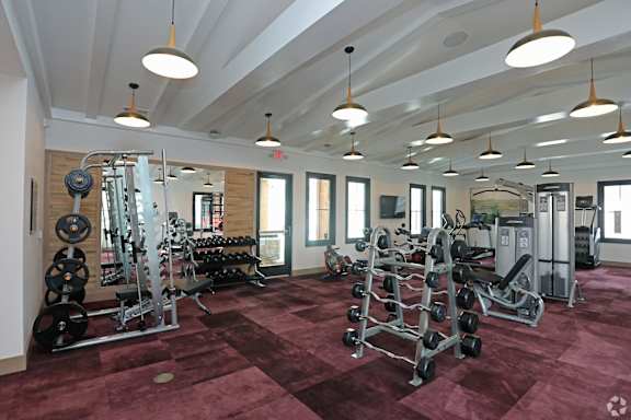 A gym with a variety of equipment including weights and weight machines.at 198 Milltown Apartments, Burlington North Carolina