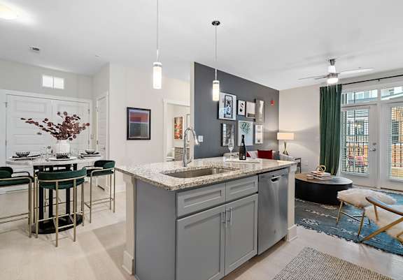 A modern kitchen with a large island and bar stools.at 198 Milltown Apartments, North Carolina