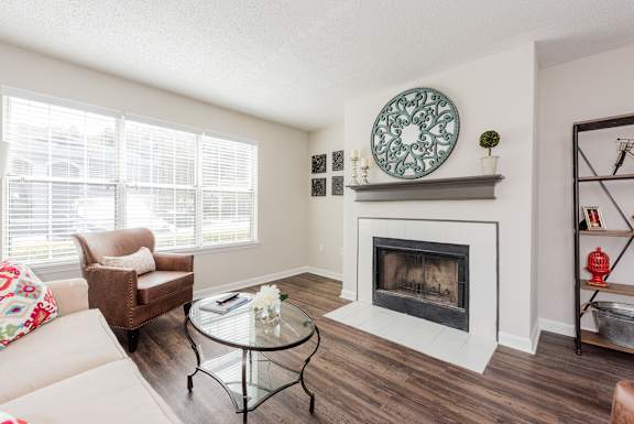 A living room with a fireplace and a couch. at WildForest Apartments, Birmingham, Alabama