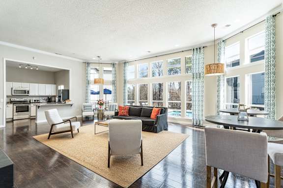 a living room with a couch and chairs and a table at WildForest Apartments, Birmingham, Alabama