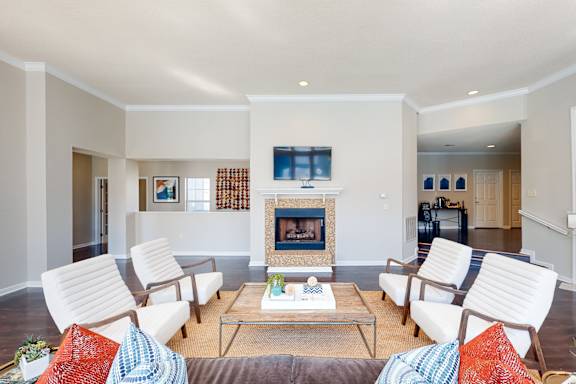 a living room with white furniture and a fireplace at WildForest Apartments, Birmingham, Alabama