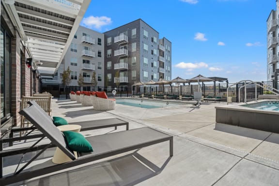 a pool with lounge chairs and umbrellas