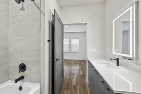 En suite bathroom with modern fixtures and soaking tub at Azalea Luxury Tampa Apartments