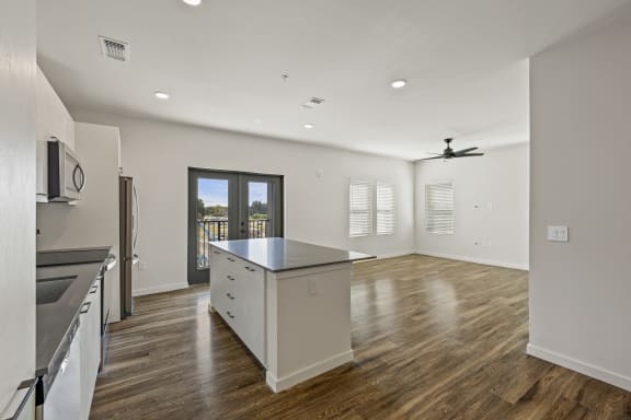 An open concept living room and kitchen with attached balcony at Azalea, Luxury Tampa Apartments