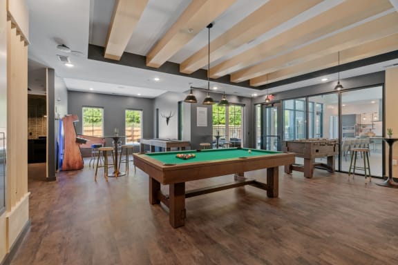 a game room with a pool table and a bar at The Lodge at Overland, Rochester, Minnesota
