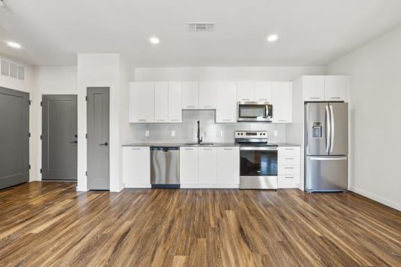 Renovated kitchen with white cabinets and stainless steel appliances  at Azalea Luxury Tampa Apartments