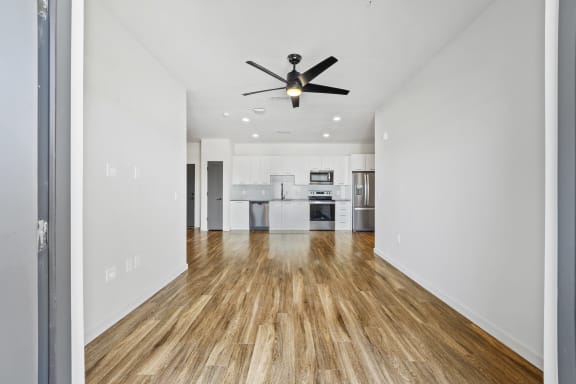 Open concept living room with a ceiling fan and a new kitchen at Azalea Luxury Tampa Apartments