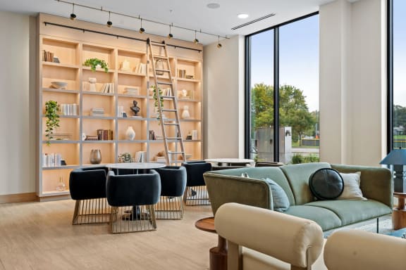 a living room filled with furniture and a large window