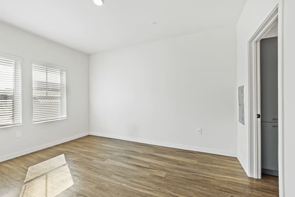 One bedroom apartment bedroom layout with wood floors and white walls at Azalea, Luxury Tampa Apartments