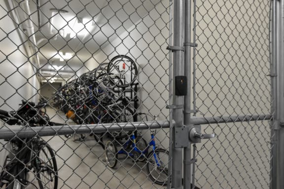 a bunch of bikes are piled up behind a fence at Park 205, Park Ridge
