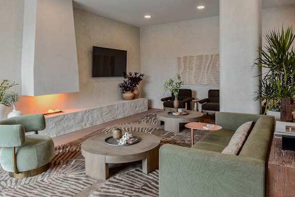 A living room with a green couch and a coffee table.