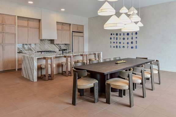 A modern kitchen with a dining table and chairs.
