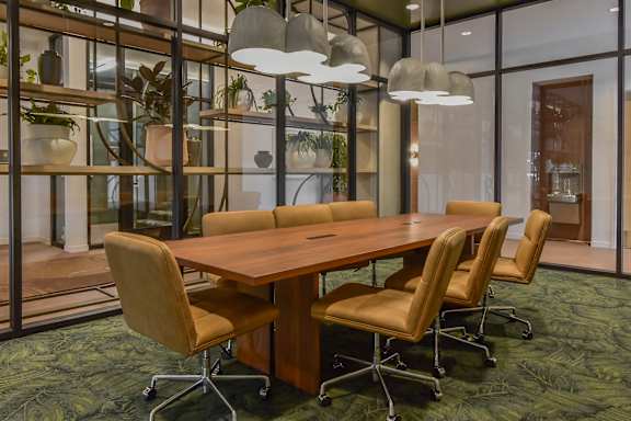 A conference room with a long table and chairs.