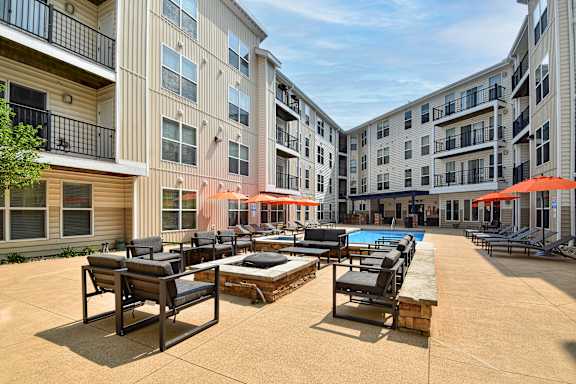 A sunny day at the poolside of apartment buildings.