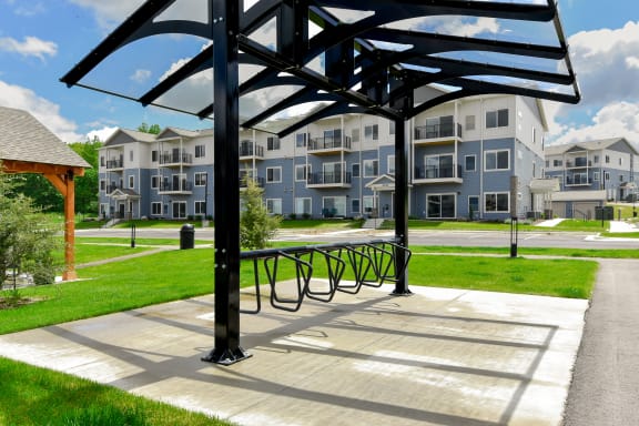 a picnic area with benches in front of an apartment building at The Lodge at Overland, Minnesota, 55901